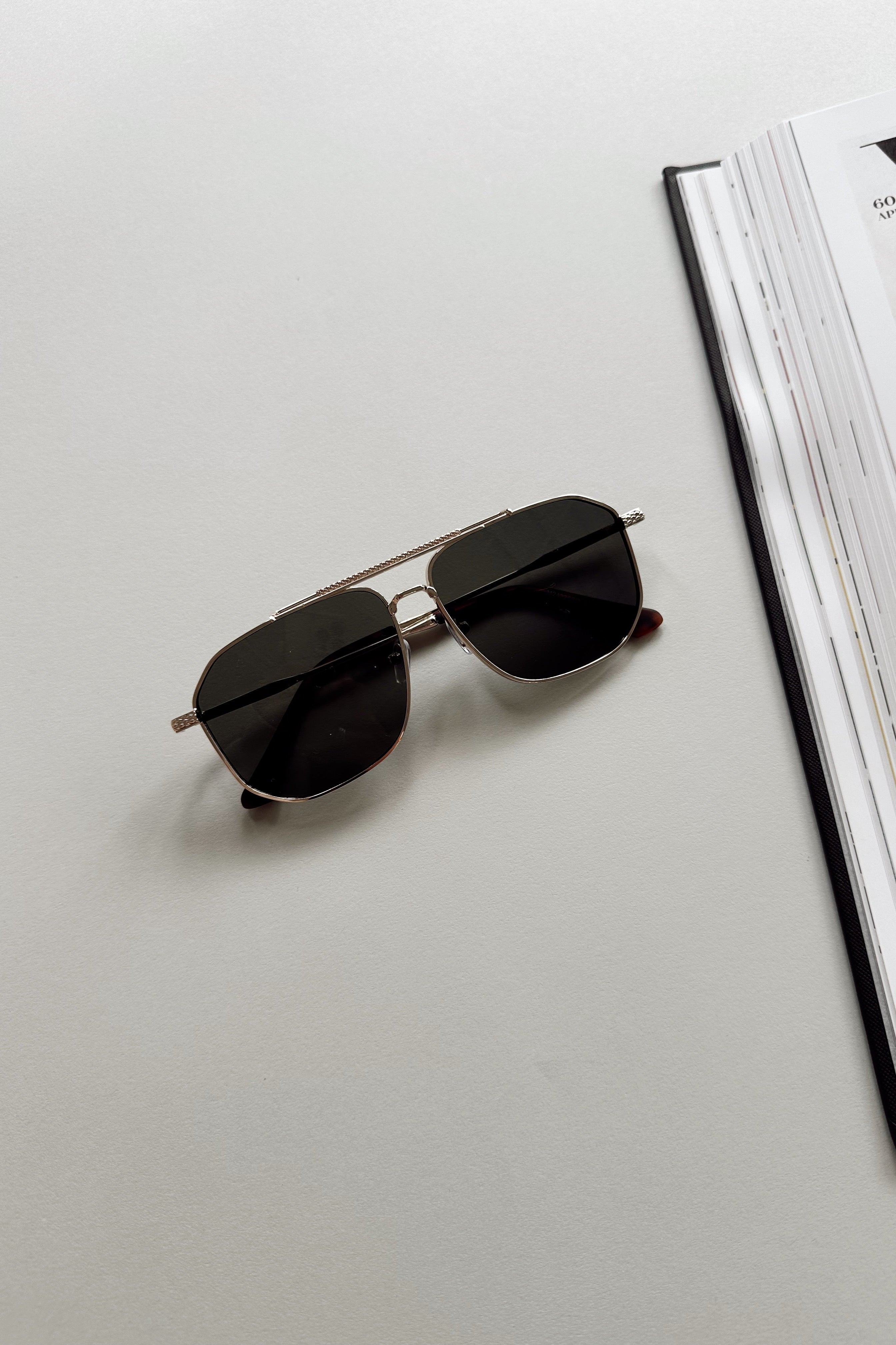 Regan Sunglasses in Gold & Black - flat lay - front view