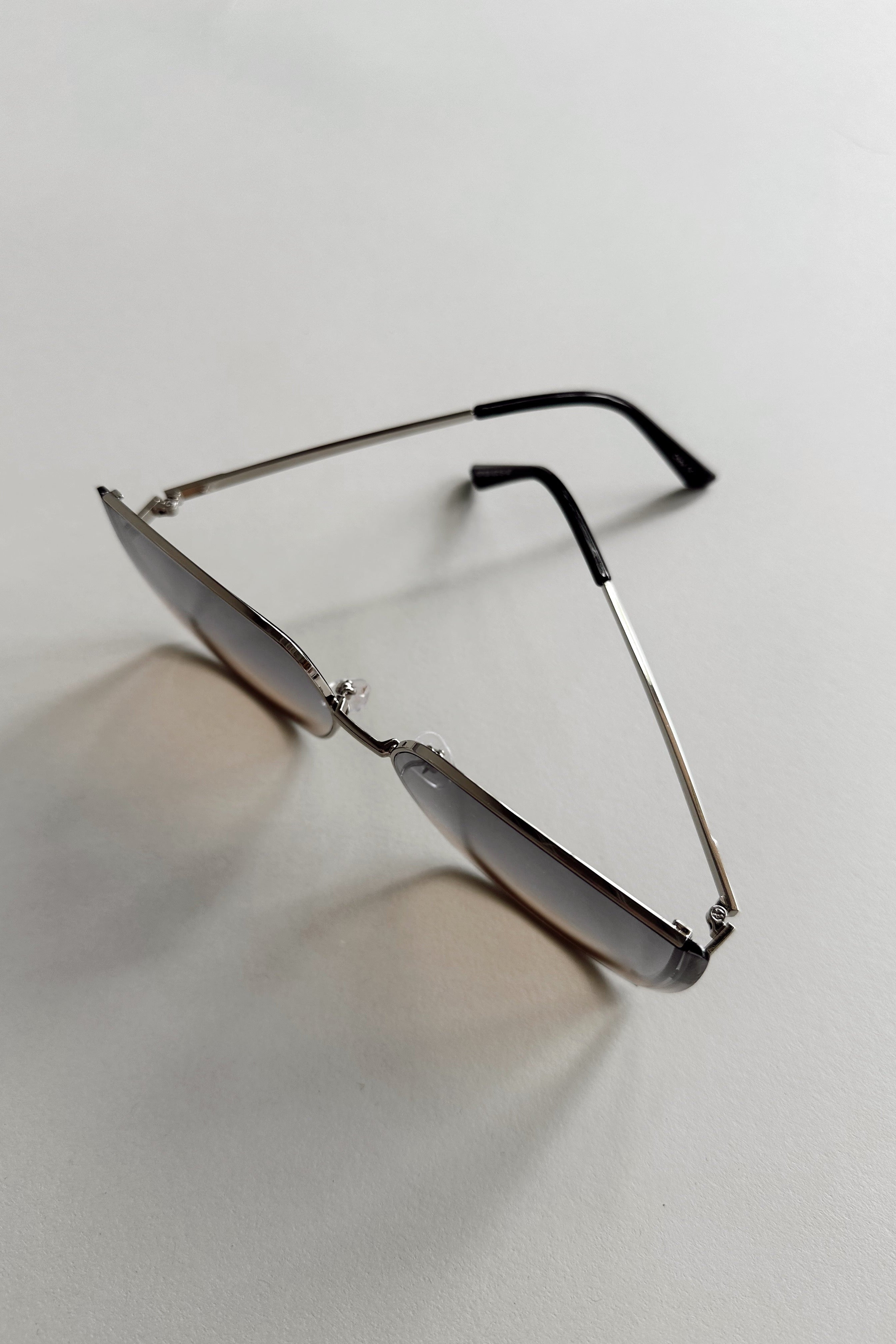 Serena Sunglasses in Silver & Black - flat lay - top view