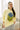 model wearing a yellow sweater with printed blueberries graphic
