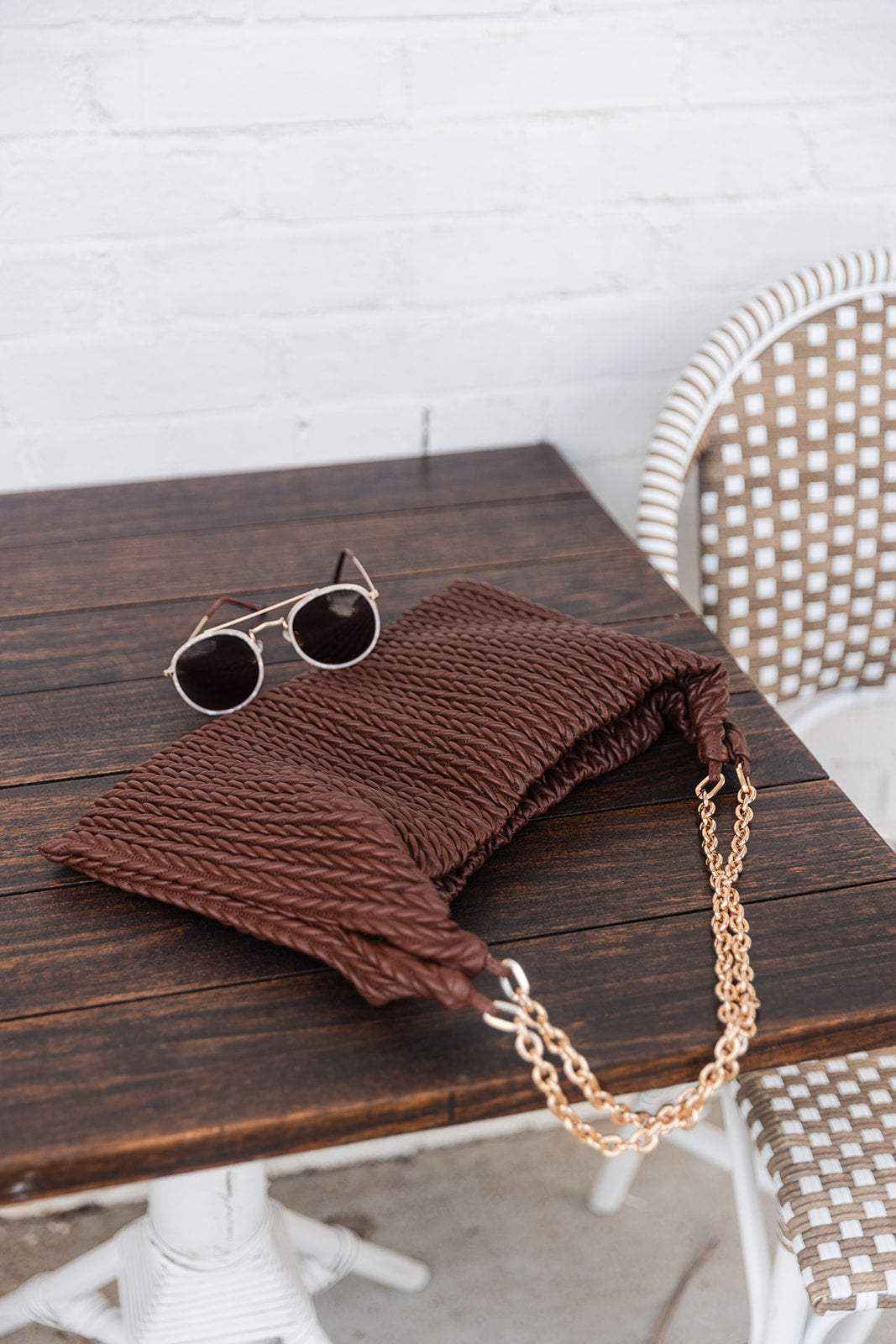 Shelby Brown Faux-Leather Purse - shown on table