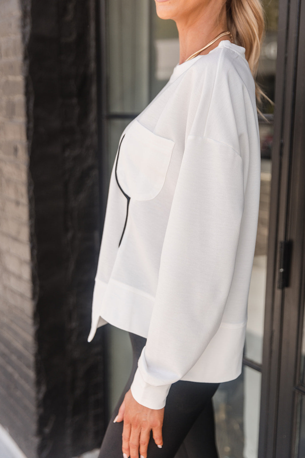 Aspen White & Black Pocket Sweatshirt- close up side view