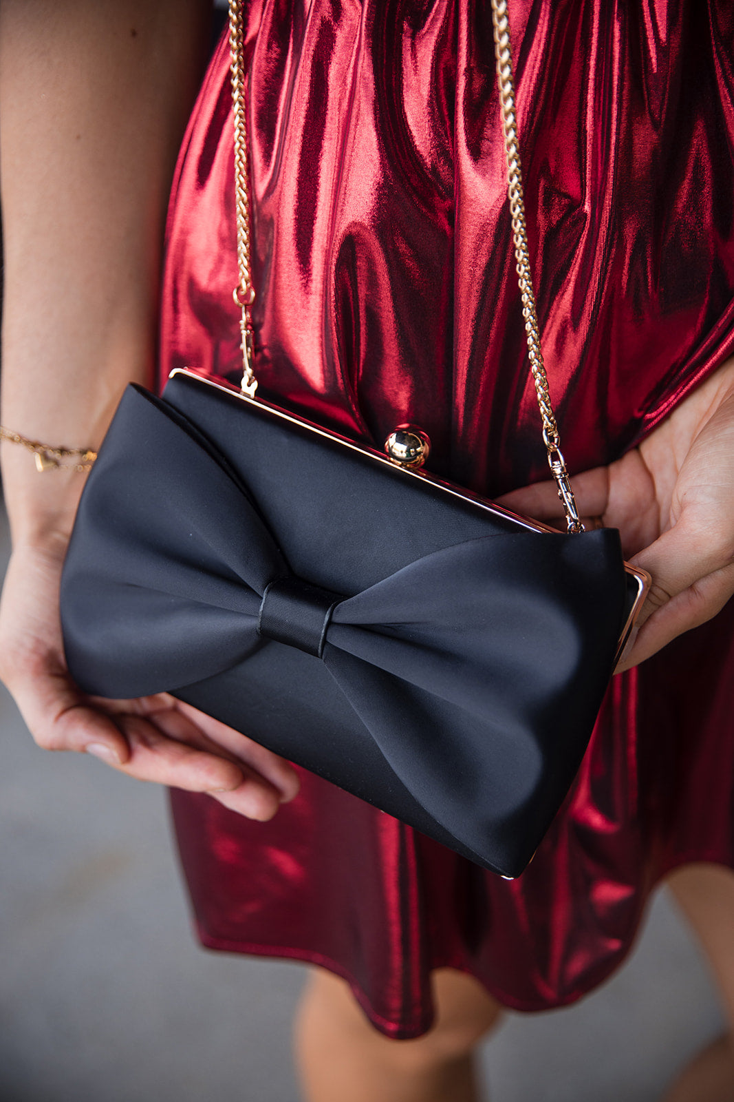 Lillian Black Bow Clutch - Frontal view on model