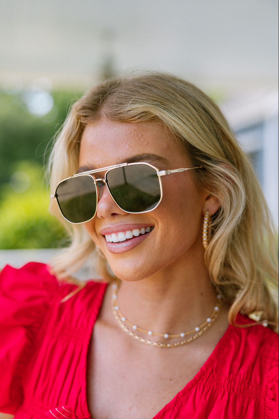 Regan Sunglasses in Gold & Black - front view on model