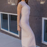 Full body side view of model wearing the Chloe Light Pink Mesh Lined Maxi Dress which features light pink mesh fabric, light pink lining, maxi length, a high neckline, and short sleeves.