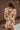 Back view of model wearing the In Your Dreams Top, that has an ivory knit material, a mocha geometric print, a collar neck, a long sleeve, and a button-up front. Worn over whit tank with with matching skirt.