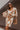 Front view of model wearing the In Your Dreams Top, that has an ivory stretchy knit material, a mocha colored geometric print, a collar neck, a long sleeve, and a button-up front. Worn over whit tank with with matching skirt.