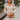 Front view of model wearing the Take Your Time Dress, which features an ivory knit material, a taupe striped pattern, a straight neckline, a long sleeve, a mini length, and a tight fit.