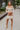 Full body front view of model wearing the Take Your Time Dress, which features an ivory knit material, a taupe striped pattern, a straight neckline, a long sleeve, a mini length, and a tight fit.