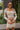 Front view of model wearing the Take Your Time Dress, which features an ivory knit material, a taupe striped pattern, a straight neckline, a long sleeve, a mini length, and a tight fit.
