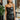 Front view of model wearing the Big Reputation Dress, which features a black faux-leather material, a surplice, sweetheart neckline, a sleeveless design with thin adjustable straps, a draped front, a surplice bottom, and a zip-up back closure