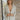 Front view of the Glitz and Glam Blazer features champagne glitter fabric, champagne button closures, low collared neckline, has a lining, left chest pocket and long sleeves.