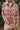 Front view of the Side Lines Flannel features rust, light orange, light blue, taupe and cream coloring fabric, plaid pattern, rust button up with a collared neckline, front left chest pocket, slits on each side of them hem and long sleeves with buttoned c