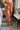 Front view of model wearing Running Up That Hill Joggers features a brown colored nylon material, a high-rise fit, a thick elastic waist with an adjustable tie, side pockets, and a jogger fit.