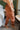 Side view of model wearing Running Up That Hill Joggers features a brown colored nylon material, a high-rise fit, a thick elastic waist with an adjustable tie, side pockets, and a jogger fit.