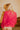 Back view of the Falling Flowers Top that features a pink colored sheer material, a stitched floral print, a tank top lining, a high neck, a long sleeve, a back button closure at the neck, and a flowy fit.