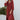Full body front view of model wearing the Seasons Change Maxi Dress, which has a rust colored fabric, a V neckline, long sleeves, a button-up front, a babydoll design, a midi length, and a flowy fit.