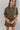 Frontal view of the The Lady May Romper that features an olive green fabric, a collar neckline, a short cuffed sleeve, a button-up front, two front pockets at the chest, a cuffed bottom hem, and two back pockets.