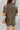 Back view of the The Lady May Romper that features an olive green fabric, a collar neckline, a short cuffed sleeve, a button-up front, two front pockets at the chest, a cuffed bottom hem, and two back pockets.