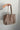 Angela Taupe Suede & Studs Tote - model shown holding tote