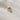 Diamond rhinestone gold charm against a white background.