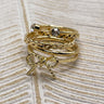 Image shows the Heather Gold Bow Ring Set stacked against a beige background.