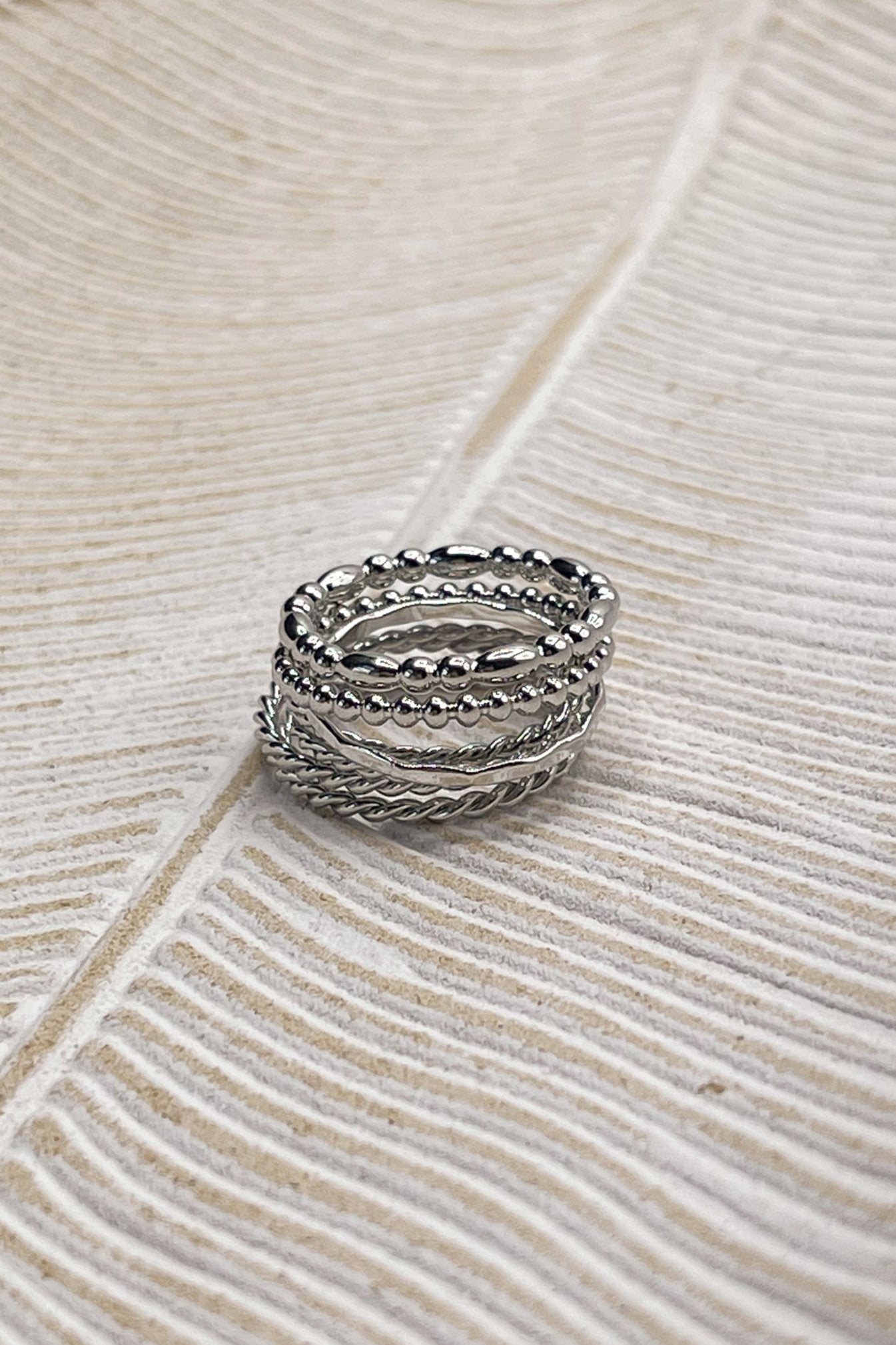 Image shows the Misha Silver Ring Set stacked against a beige background.