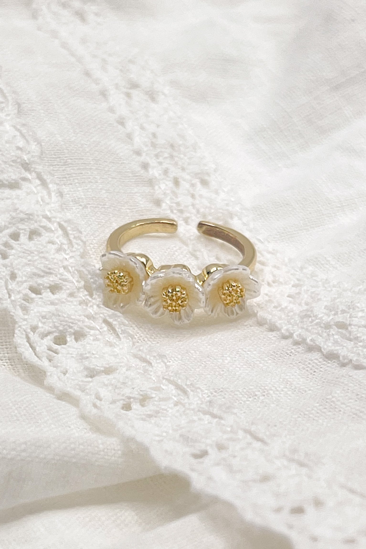 Image shows the Anabelle White & Gold Flower Ring against a white background.