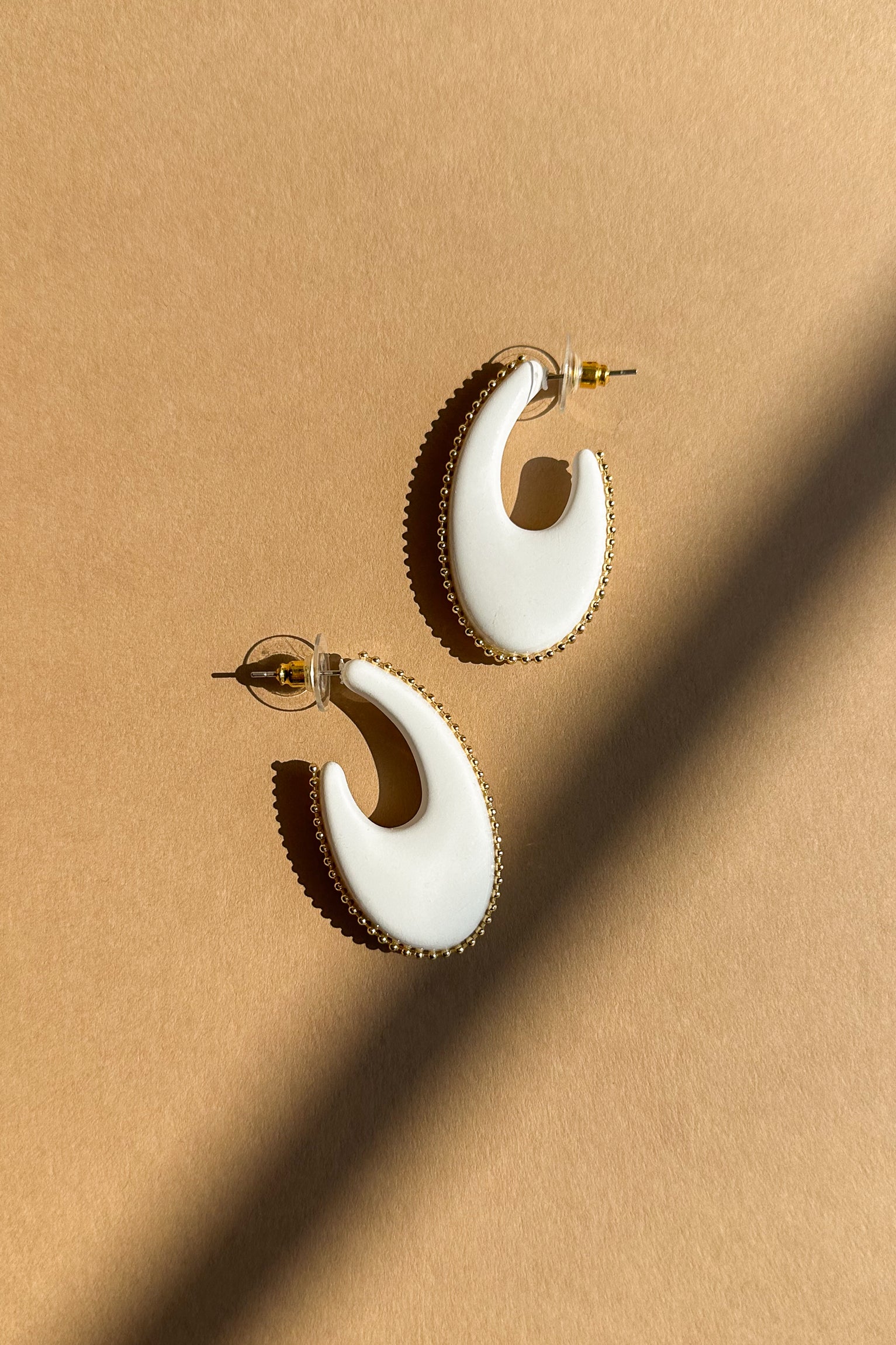 Amira White & Gold Scoop Hoop Earring- flat lay view