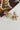 Claudia Gold Floral Earrings - close up flat lay
