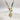 Close up of medallion on Stella White Opal Gold Necklace, that is a gold chain link with turquoise beads and white opal medallion with a star detail.