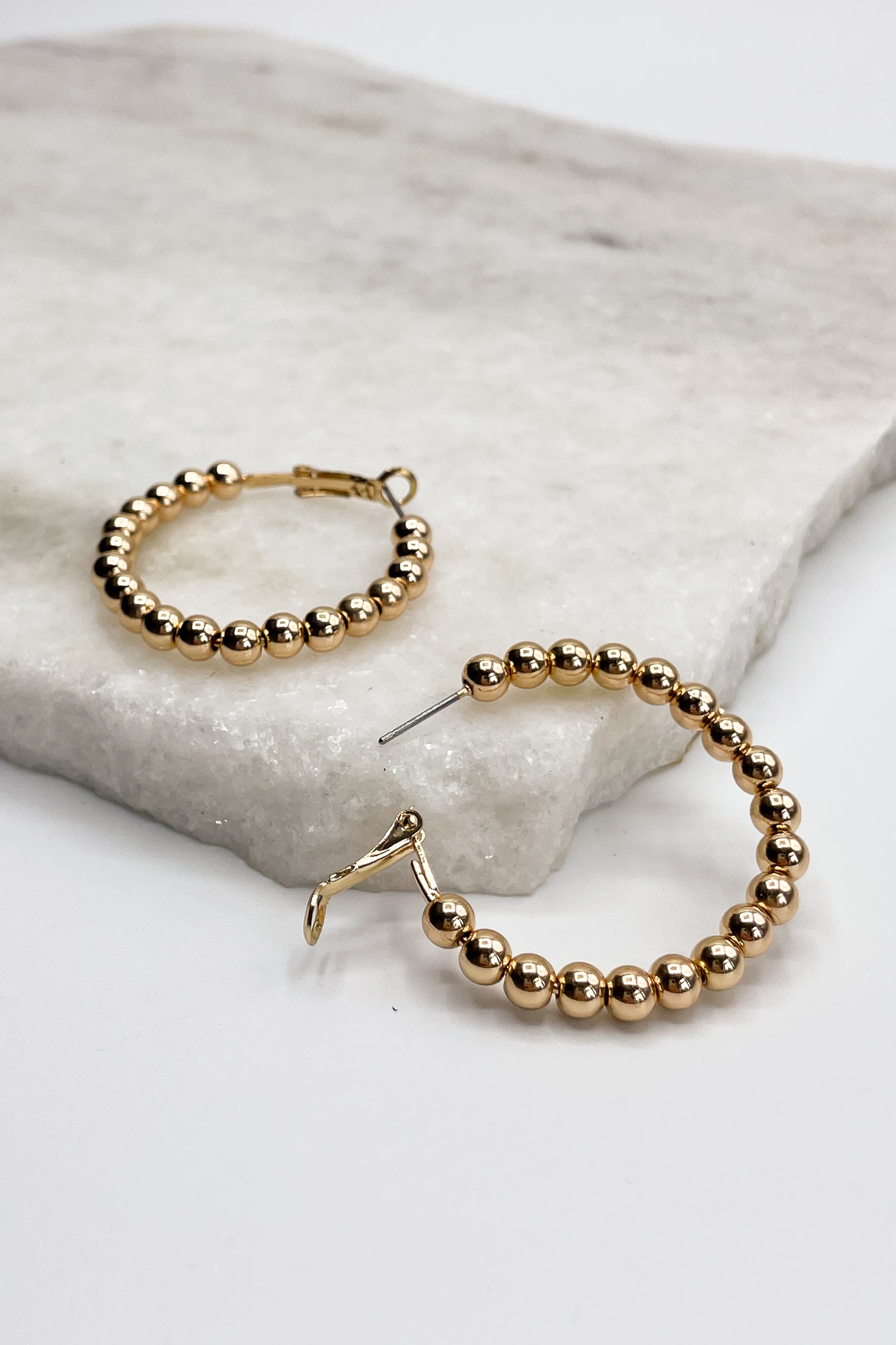 Close up of Sophie Gold Beaded Hoops, gold beaded medium closed hoops.