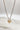Close up of Mama Gold Heart Necklace, adjustable gold chain link with a gold heart "MAMA" medallion.