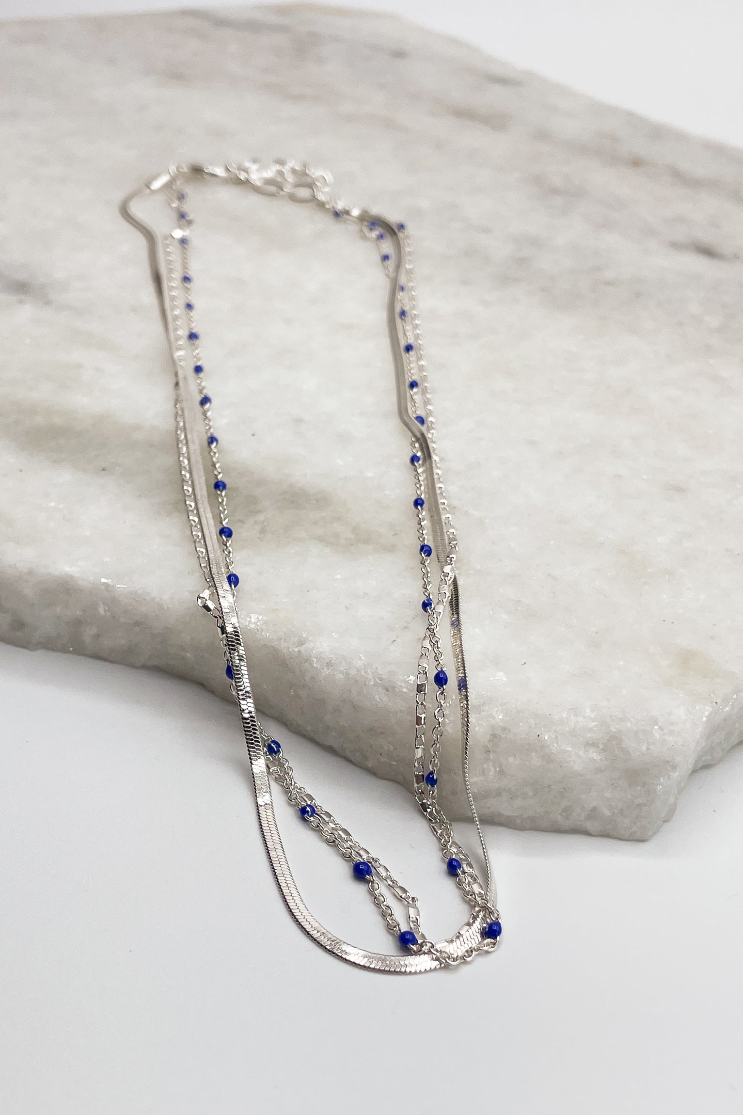 Full view of Kenzie Silver Layered Necklace, silver chain link layer with blue beads.