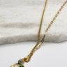 Close up of Meredith Gold Lock and Bead Necklace, adjustable gold chain link with a gold lock medallion and turquoise beads.