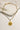 flat lay view of the Starburst Gold Chain Link Necklace which features adjustable gold chain link with a hammered medllaion and starburst detail
