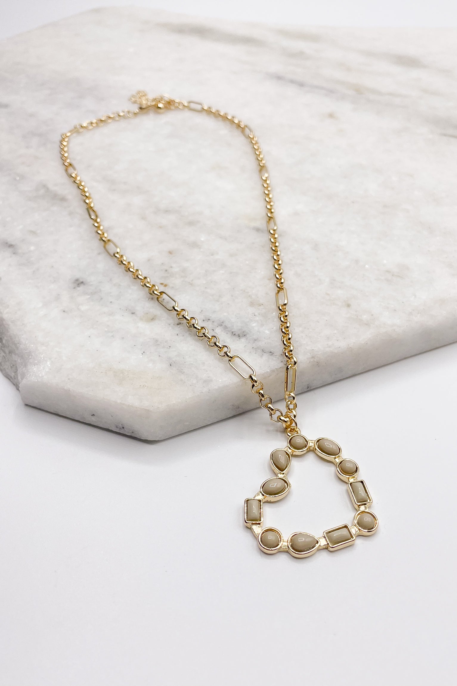 Close up of the Rylee Gold Heart Necklace. This is a gold necklace with bead heart.