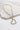 Close up of the Rylee Gold Heart Necklace. This is a gold necklace with bead heart.