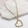 Close up of the Rylee Gold Heart Necklace. This is a gold necklace with bead heart.