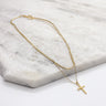 Close up of Eliza Gold Layered Cross Necklace. This is a gold necklace, layered with a cross.