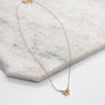 Close up of Charlotte Gold Bow Necklace. This is a gold necklace with a mini rhinestone bow. 