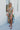 Full body front view of model wearing the Change of Heart Midi Dress, which features a satin material, a multi-colored floral print, a collared V surplice neckline, short cuffed sleeves, a tie waist, and a midi length