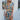 Front view of model wearing the Change of Heart Midi Dress, which features a satin material, a multi-colored floral print, a collared V surplice neckline, short cuffed sleeves, a tie waist, and a midi length