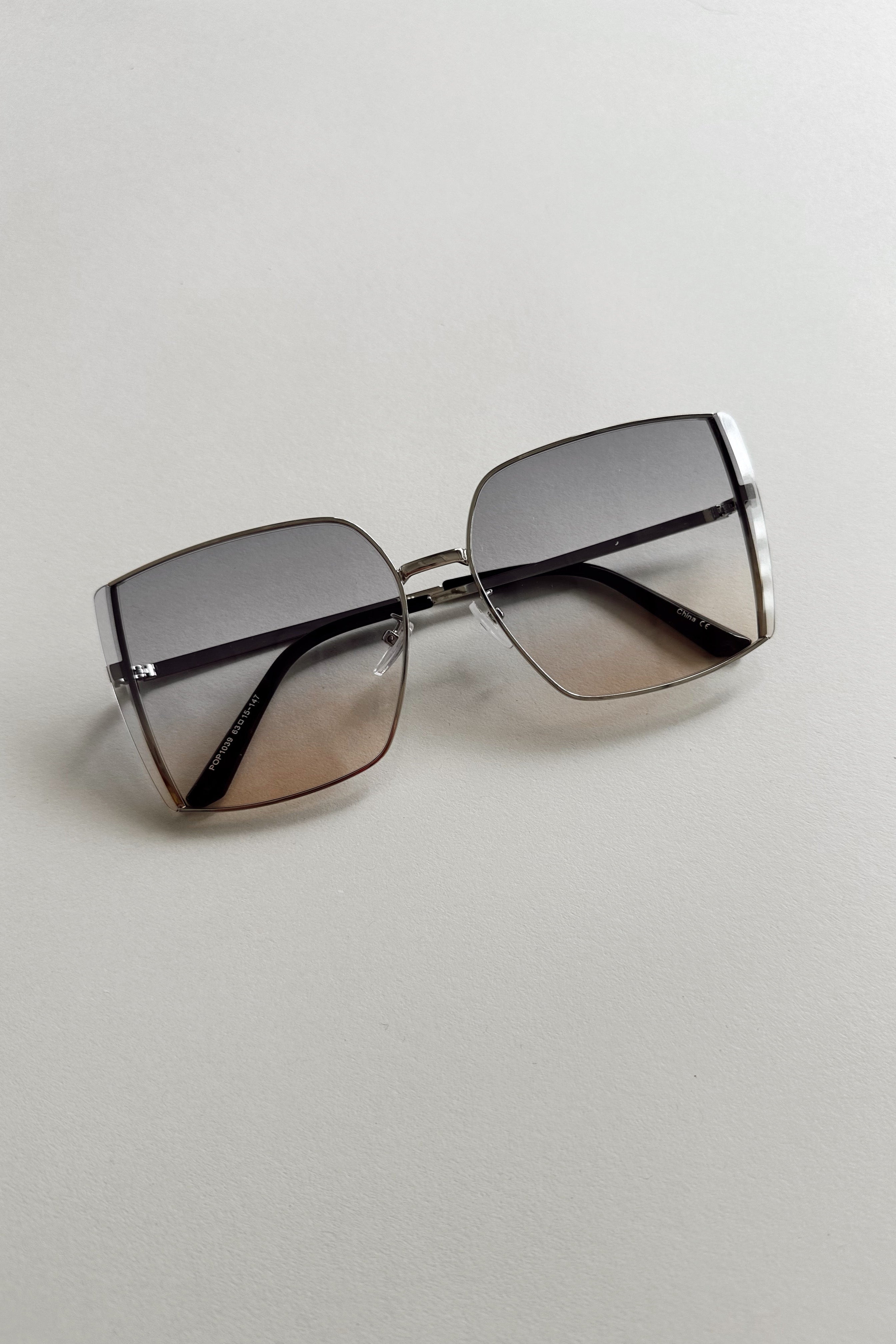 Serena Sunglasses in Silver & Blue - flat lay - front view