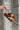 Margot Brown Low Profile Sneakers - side view held by model