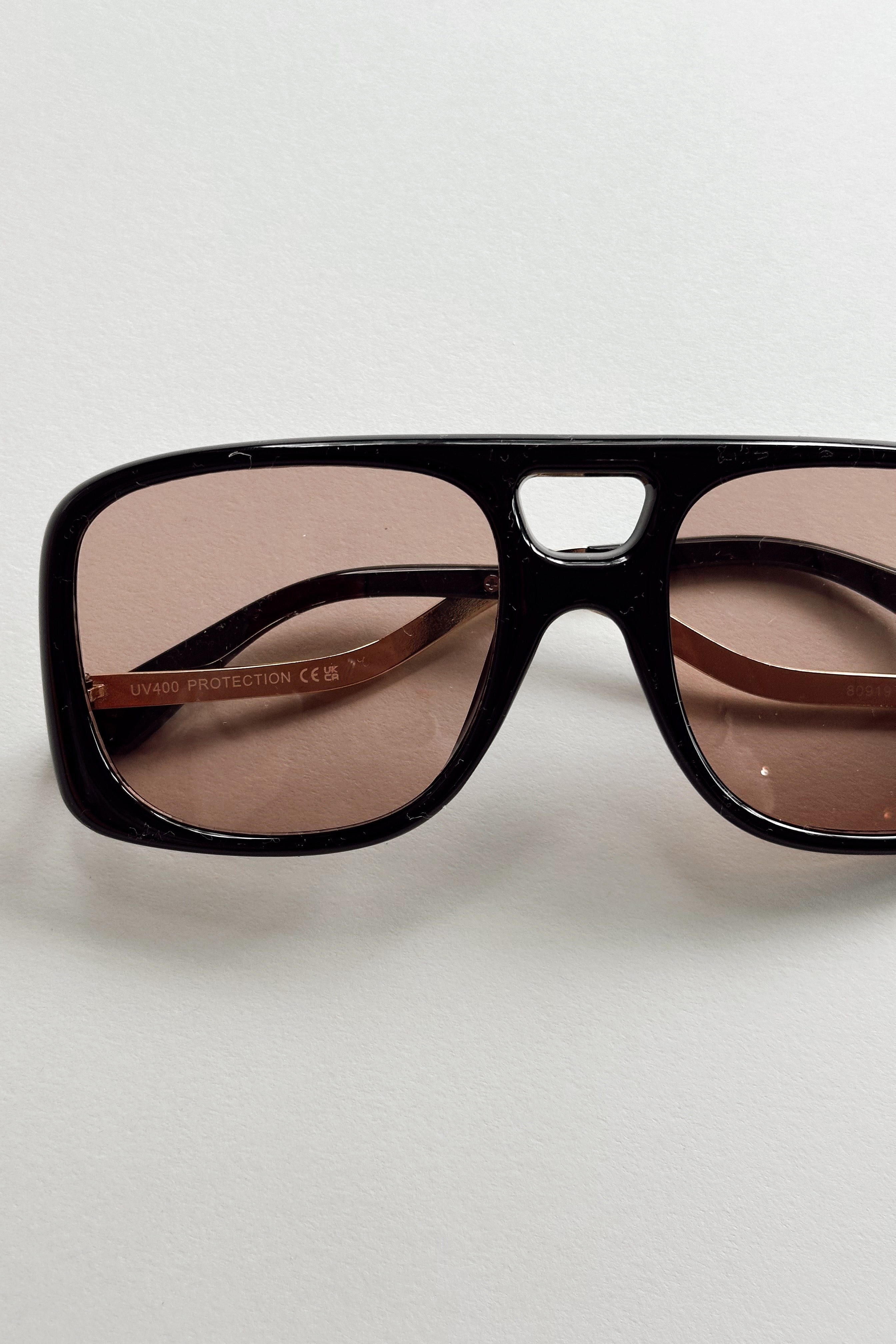 Kennedy Sunglasses in Black & Brown - flat lay - close front view