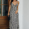 Full body view of female model wearing the Delilah Black & Cream Swirl Open Back Maxi Dress which features Black and Cream Lightweight Fabric, Swirl Pattern Details, Maxi Length, Sweetheart Neckline, Adjustable Straps an dOpen Back with Tie Closures