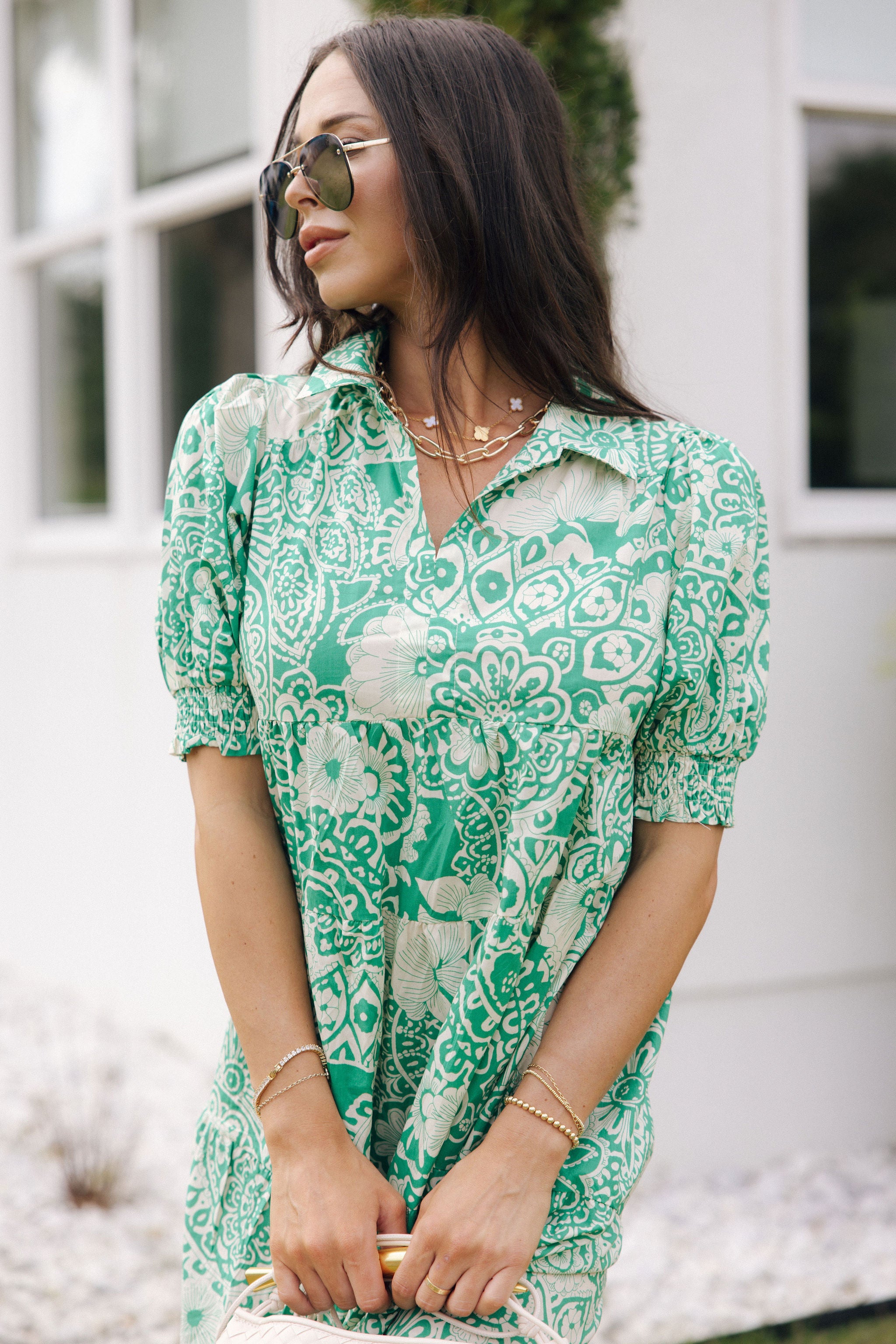 Front view of female model wearing the Celeste Green & Cream Floral Paisley Midi Dress which features Green and Cream Floral Paisley Pattern, Midi Length, Tiered Body, V-Neckline with Collar and Short Puff Sleeves