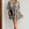 Full body  view of female model wearing the Raelynn Black & Cream Floral Paisley Mini Dress which features Black and Cream Lightweight Fabric,  Floral and Paisley Print, Mini Length, Tiered Body, Quarter Button-Up, Collared Neckline and Short Sleeves 