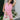 Front view of female model wearing the Palmer Pink Ruffle Halter Sleeveless Romper which features Pink Lightweight Fabric, Pink Shorts Lining, Surplice Neckline with Halter Neck Ties, Ruffle Hem Details, Open Back and Back Zipper with Hook Closure
