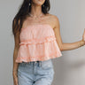 Front view of female model wearing the Millie Peach Ruffle Strapless Top which features Peach Cotton Fabric, Ruffle Tiered Body Details, Peach Lining, Cropped Waist and Strapless